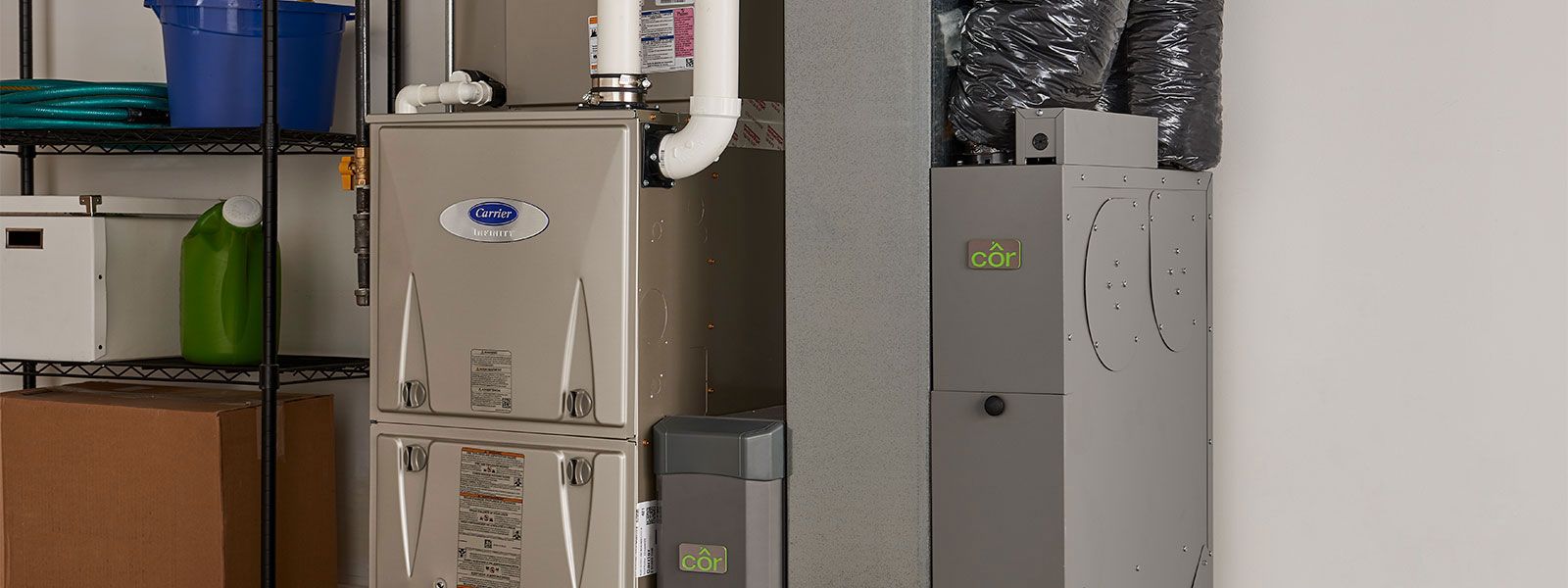 A silver Carrier company infinity furnace in a garage