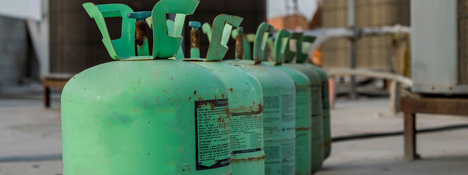 Row of green R-22 tanks near rooftop units