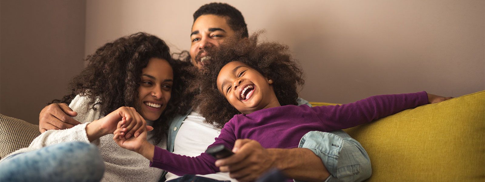 Family having fun on couch at home