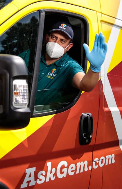 Technician waving out window of van