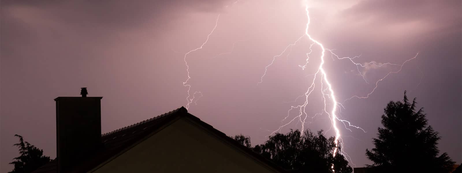 Lightning strike above dark home
