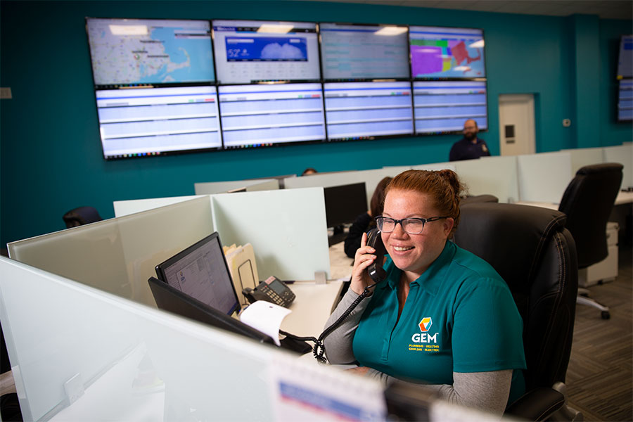 GEM Plumbing & Heating call service representative taking a call at her desk