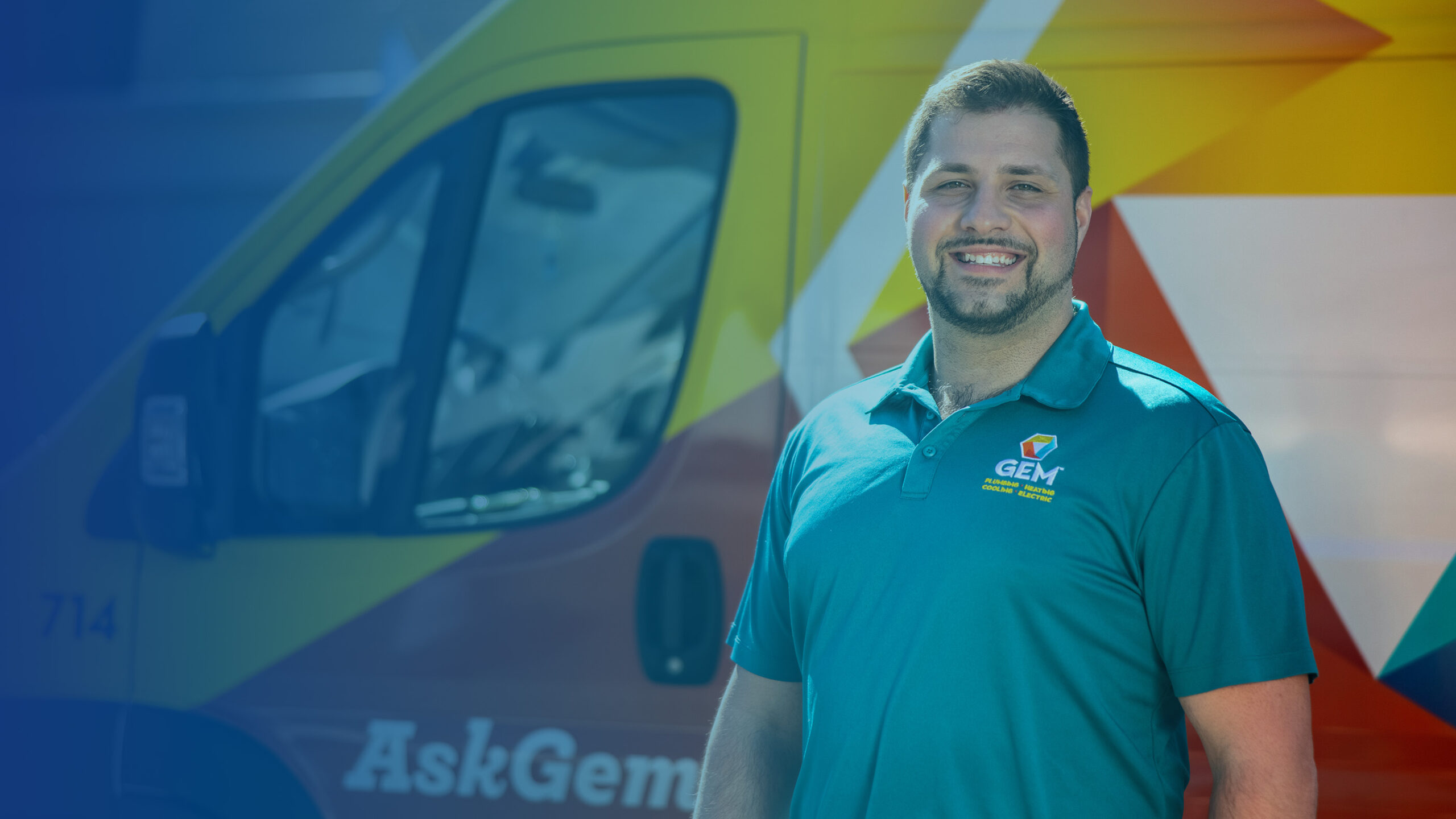 GEM tech wearing mask smiling in front of van