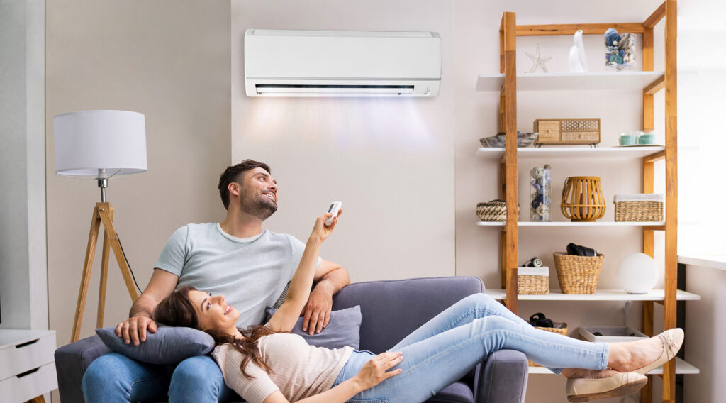 Couple enjoy cooling from new air conditioner