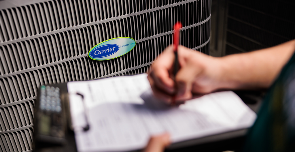 GEM technician writing service notes during home visit to determine why ac running constantly in hot weather