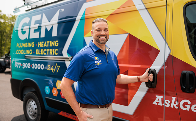 GEM service team posing together in front of branded vehicle