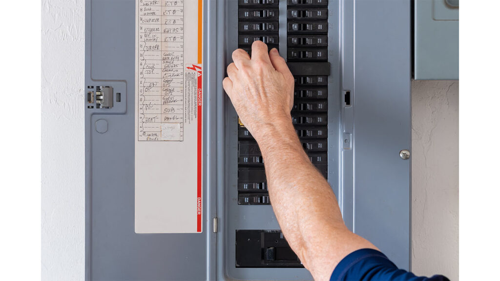 Technician adjusting thermostat inside home