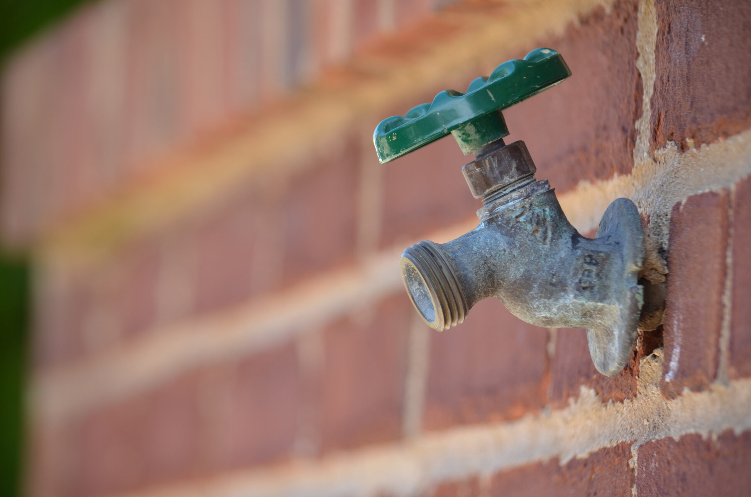 An older hose bib or water spigot like the one pictured can be a cause of outdoor plumbing leaks.
