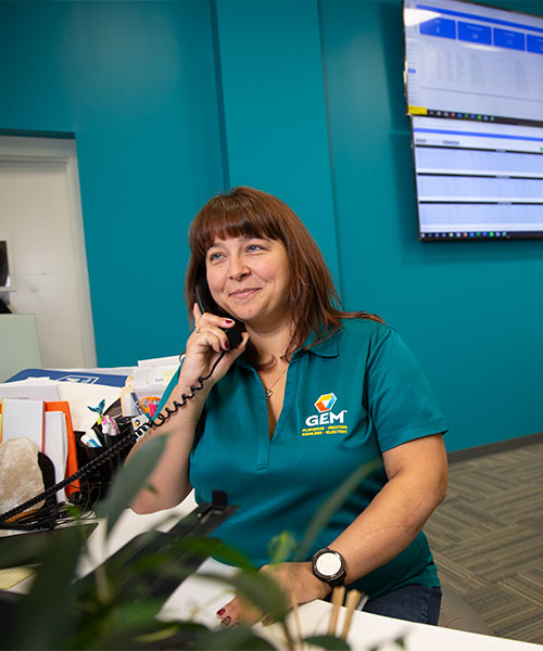 GEM Plumbing & Heating call center representative at desk