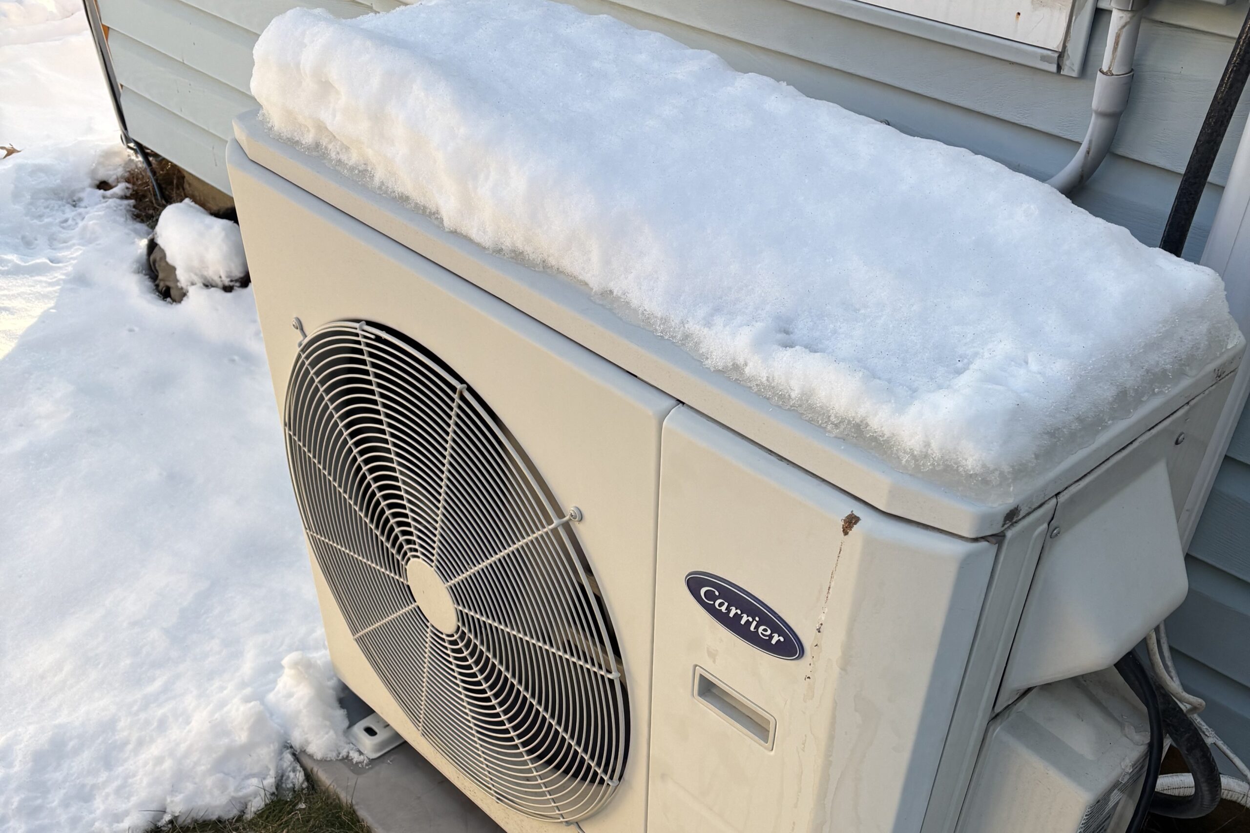 An outdoor HVAC unit is shown. GEM can help prevent winter HVAC plumbing electrical emergencies.