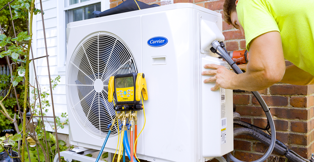GEM technician reviewing drain line clogs in air conditioners with a customer