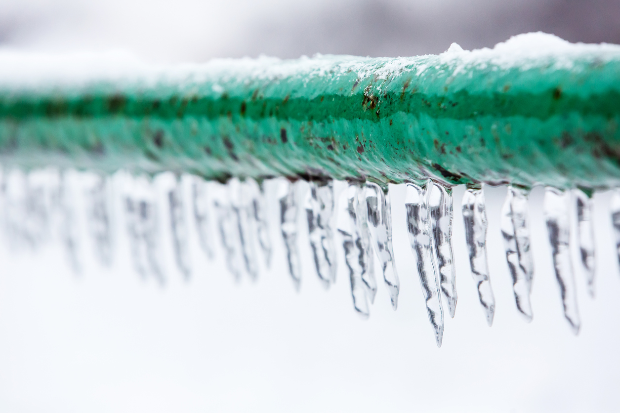 Frozen pipe covered in icicles.