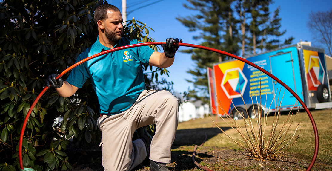 GEM HVAC technician performing outdoor system maintenance