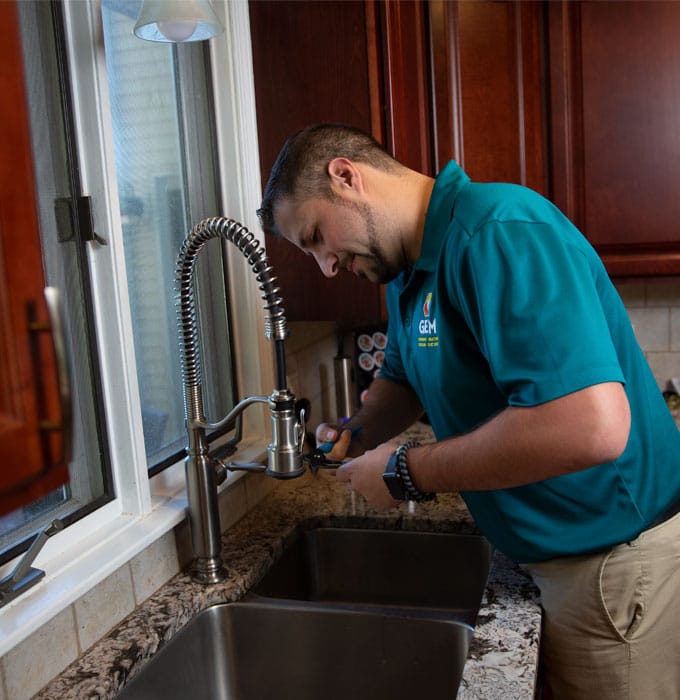 GEM Technician Repairing Sink