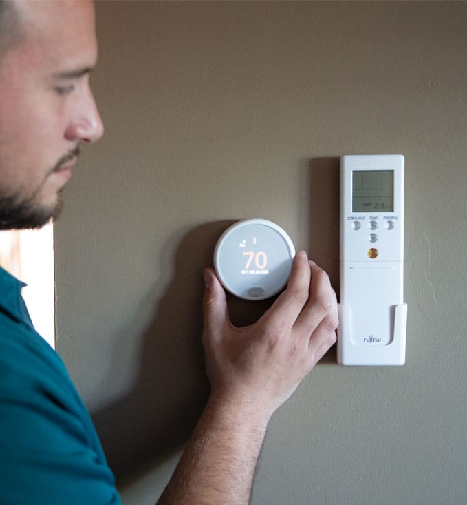 Technician Adjusting Smart Thermostat