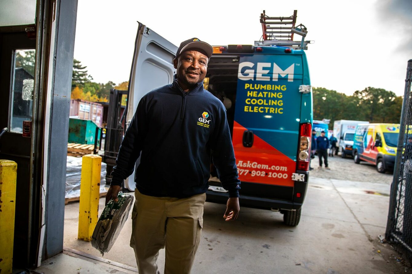 GEM technician in front of service truck