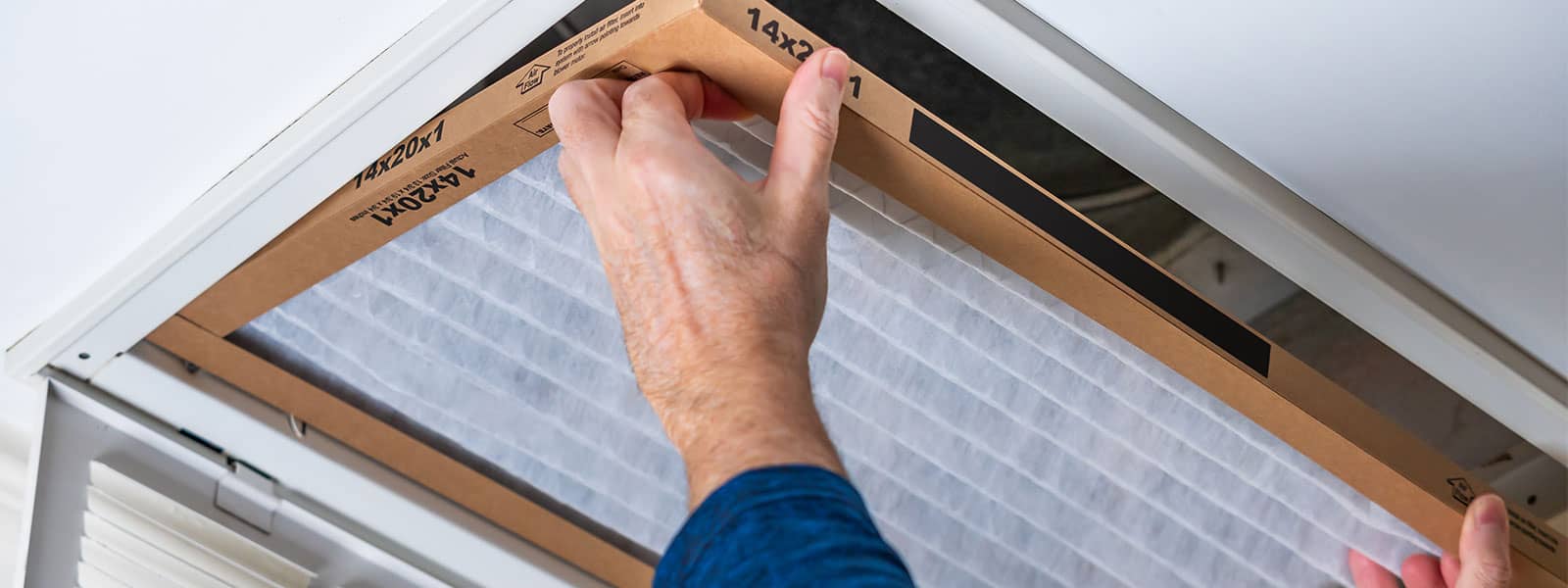 GEM technician changing filter in ceiling