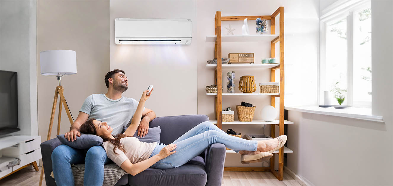 Couple enjoy cooling from new air conditioner