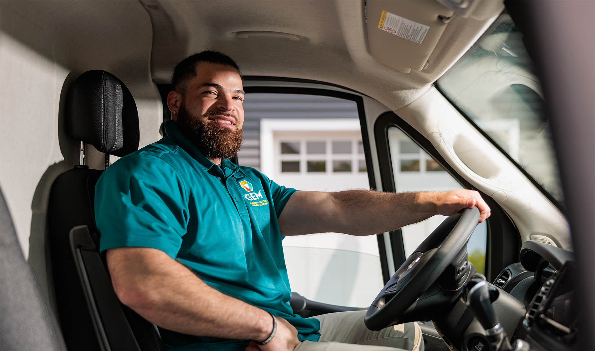 GEM employee driving a service truck