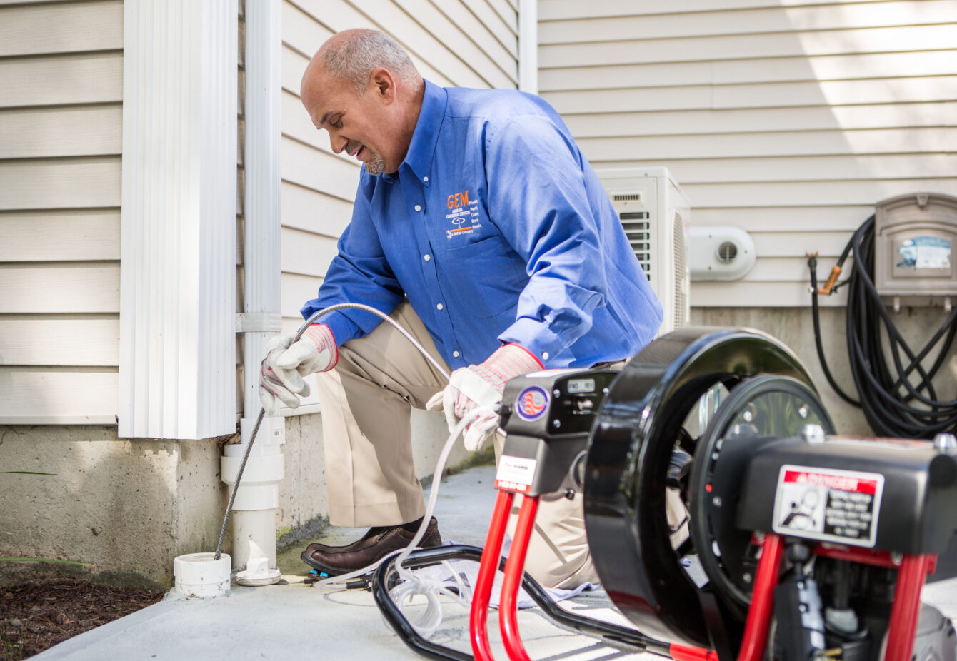 GEM plumber cleaning a drain