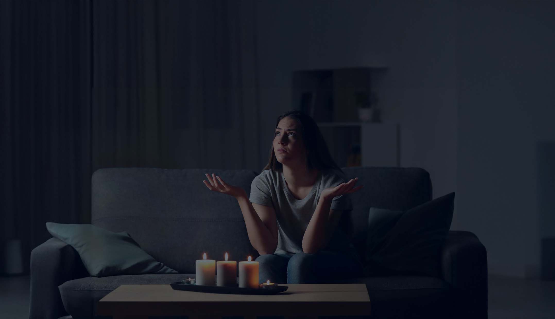 Woman sits in living room during power outage wishing she had a generator